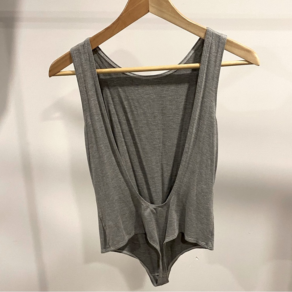 It’s Mary Young, grey backless body suit, size M